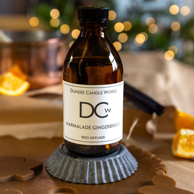 Marmalade Gingerbread Diffuser on a silver tray surrounded by gingerbread and orange slices.