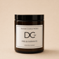 A dark amber glass jar candle with a black lid and a white label reading 'Dundee Candle Works DCw Firs & Fairways Scented Candle' on a warm beige background.
