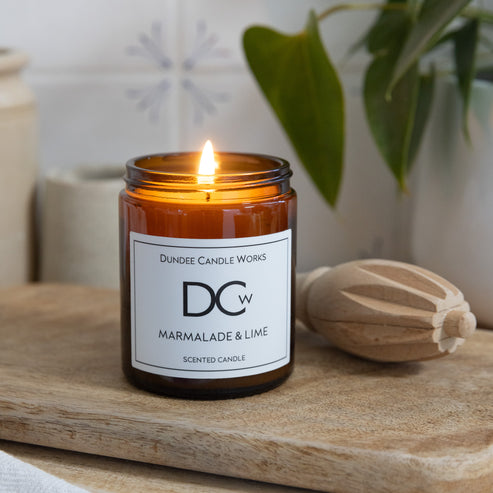 Marmalade & Lime coconut wax candle displayed in a cosy Scottish home setting.